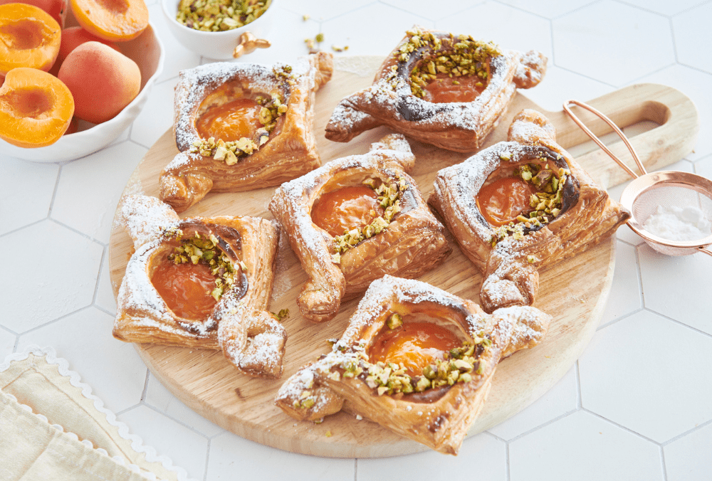 From entertaining a crowd to baking breakfast for the special sweet tooth in your life, these easy apricot danishes are just so versatile. Melt in your mouth buttery puff pastry with a cream cheese base, juicy apricot and a sublime crunch from decadent pistachio crumble, this danish recipe will have you coming back for more.