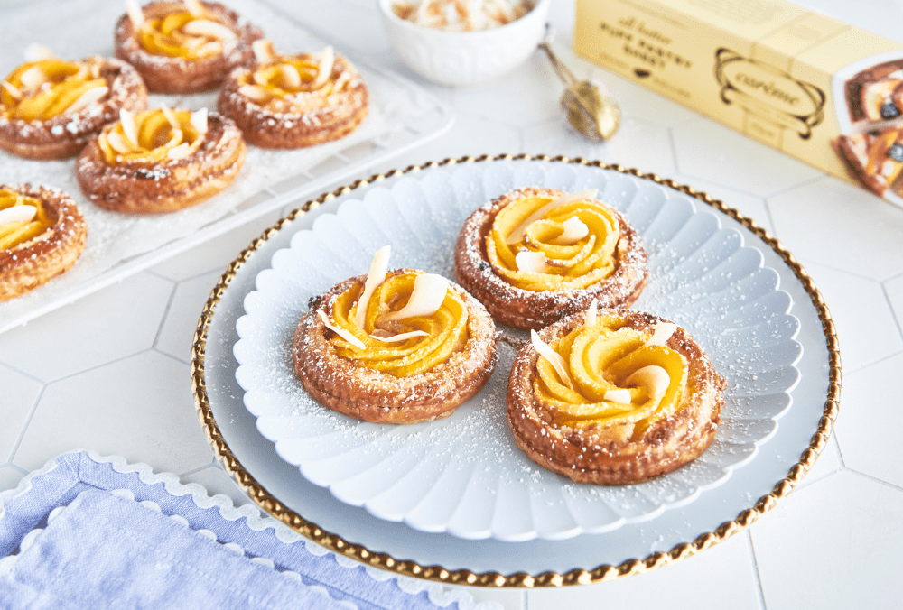 Tartlets are a must when it comes to easy entertaining. The golden pastry base of butter puff is compliment with the perfect combination of summer flavours, mango and coconut. Add in a layer of moutherwatering frangipane, flavoured with the warmth of cardamom and you've got a winning recipe!